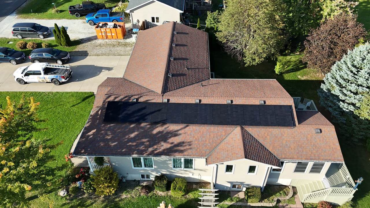 Rural home with a solar array and Ronahi truck in the driveway