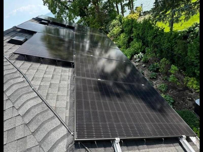 Homeowner outside a solar-powered home